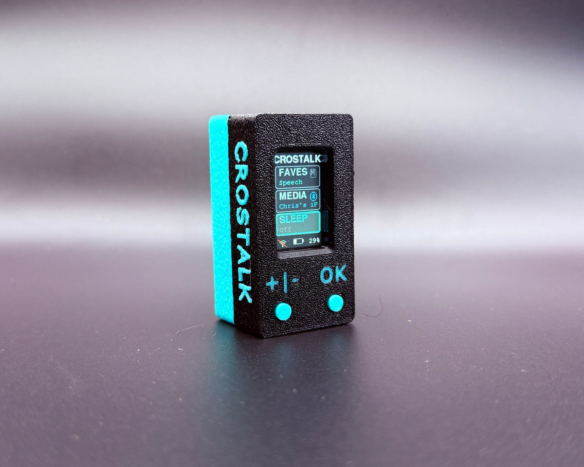 CROSTALK front three-quarter view with the screen on and raised teal CROSTALK lettering along the side