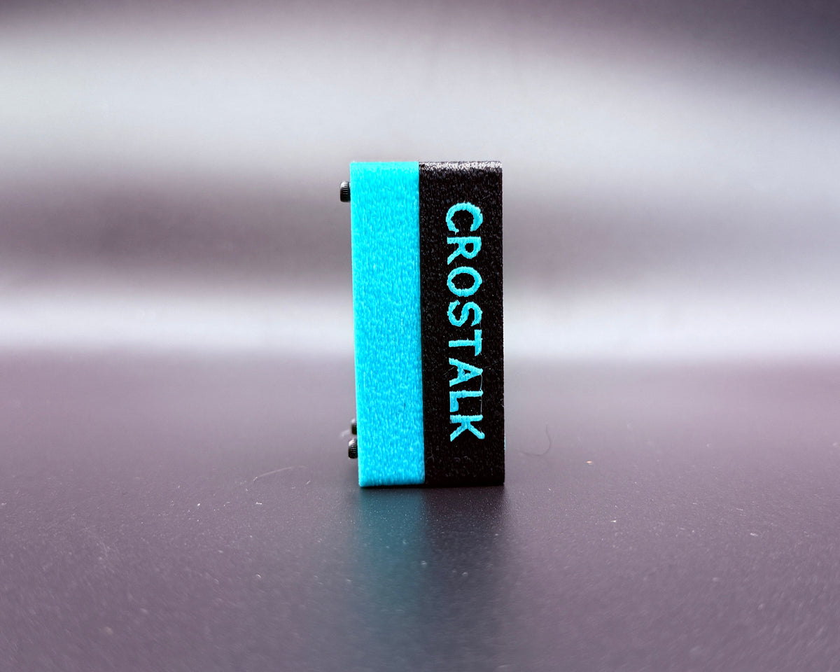 CROSTALK side view with raised teal CROSTALK lettering on the black case and a teal bottom shell