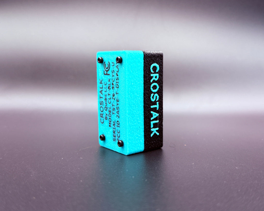 CROSTALK rear three-quarter view showing the teal bottom shell with product label and four screws, plus raised CROSTALK lettering