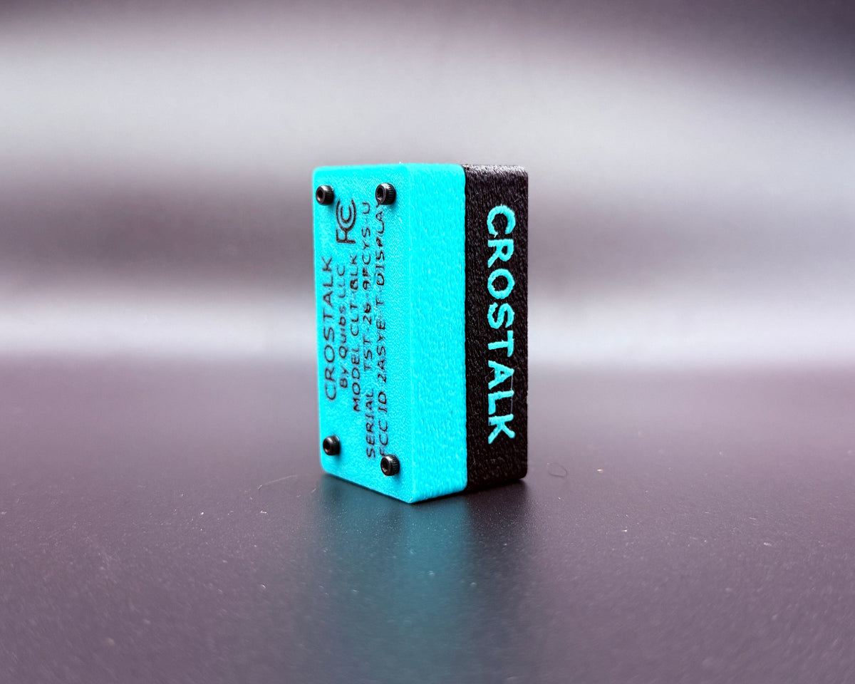 CROSTALK rear three-quarter view showing the teal bottom shell with product label and four screws, plus raised CROSTALK lettering