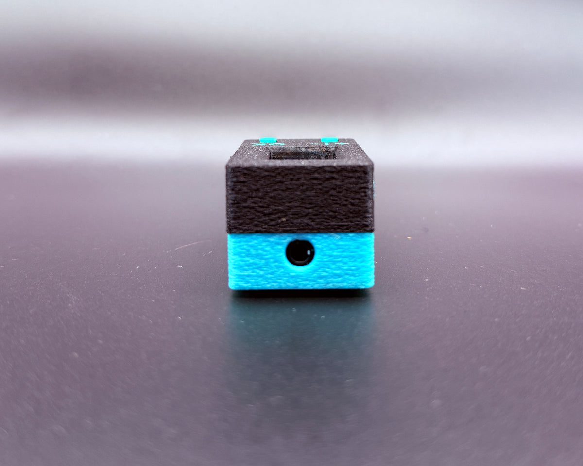 CROSTALK end view showing the 3.5mm headset jack in the teal bottom shell